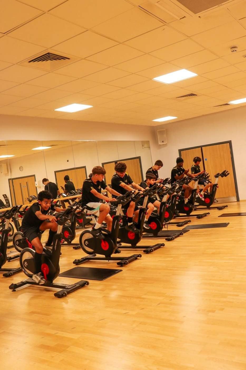 WorkRate players completing gym conditioning on exercise bikes